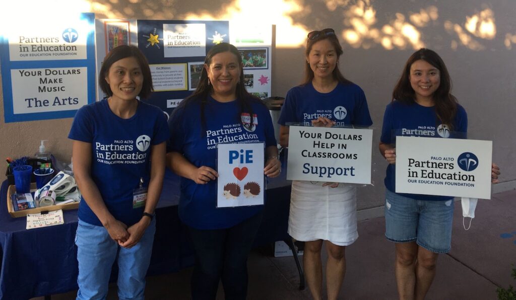 4 women holding posters