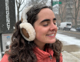 Grace Gormley wearing earmuffs and smiling in the snow